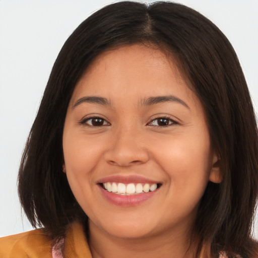 Joyful white young-adult female with long  brown hair and brown eyes