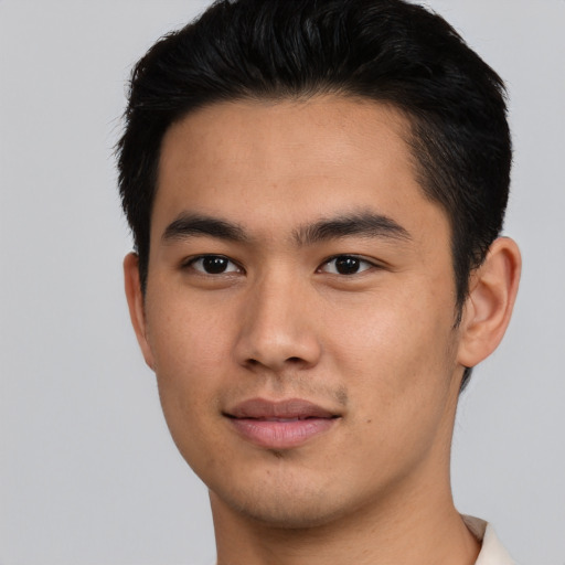 Joyful asian young-adult male with short  brown hair and brown eyes