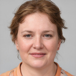 Joyful white adult female with medium  brown hair and grey eyes