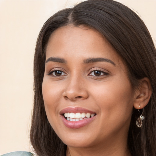 Joyful white young-adult female with long  brown hair and brown eyes