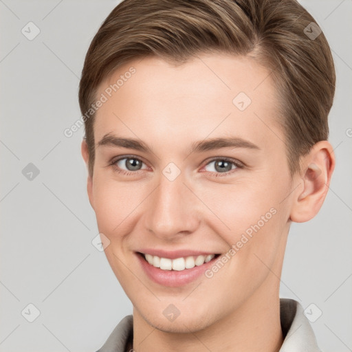 Joyful white young-adult female with short  brown hair and grey eyes