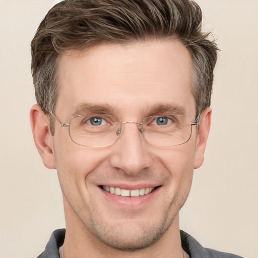 Joyful white adult male with short  brown hair and grey eyes