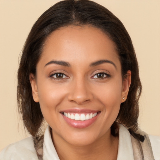 Joyful white young-adult female with long  brown hair and brown eyes