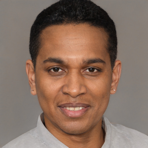Joyful latino adult male with short  black hair and brown eyes