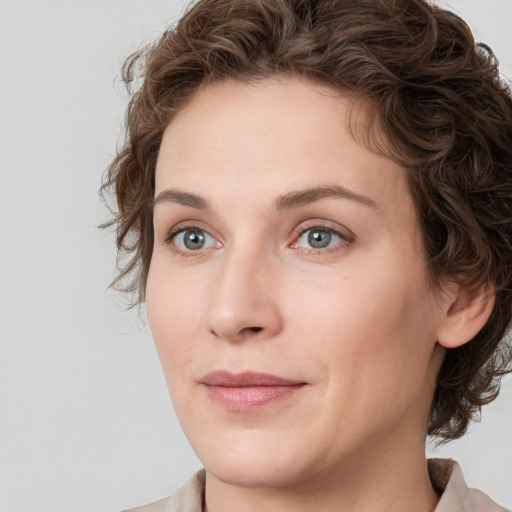 Joyful white young-adult female with medium  brown hair and green eyes