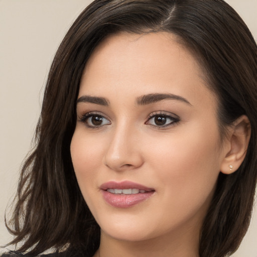 Joyful white young-adult female with long  brown hair and brown eyes