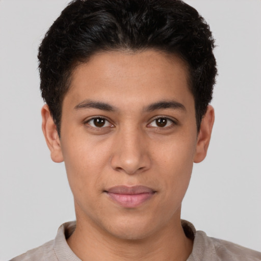 Joyful latino young-adult male with short  brown hair and brown eyes