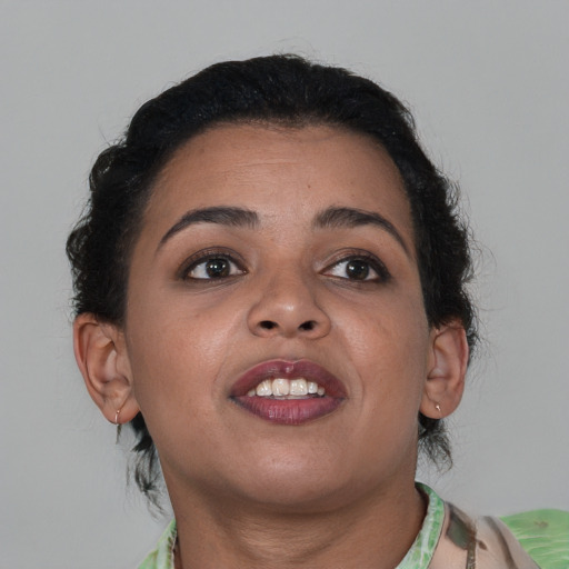 Joyful latino young-adult female with short  brown hair and brown eyes