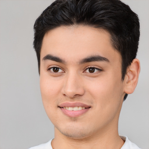 Joyful asian young-adult male with short  brown hair and brown eyes