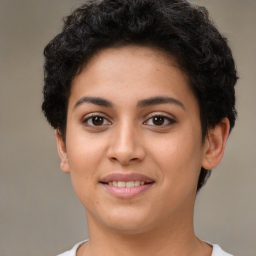 Joyful latino young-adult female with short  brown hair and brown eyes