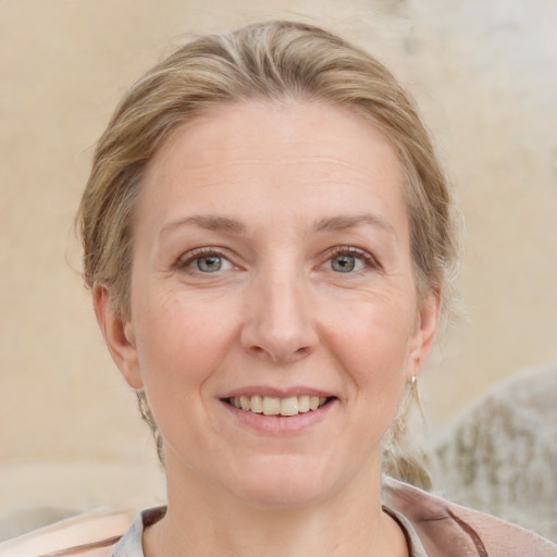 Joyful white adult female with medium  brown hair and blue eyes