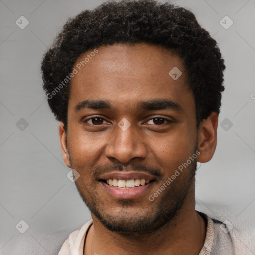 Joyful black young-adult male with short  black hair and brown eyes