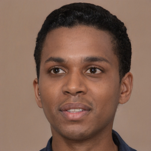 Joyful black young-adult male with short  black hair and brown eyes