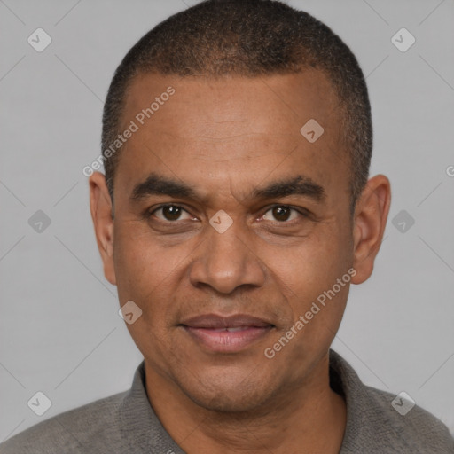 Joyful latino adult male with short  brown hair and brown eyes