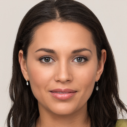 Joyful white young-adult female with long  brown hair and brown eyes