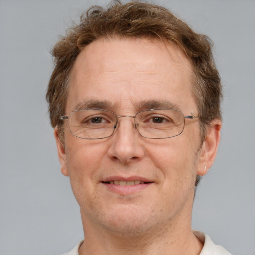 Joyful white middle-aged male with short  brown hair and grey eyes