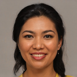 Joyful asian young-adult female with medium  brown hair and brown eyes