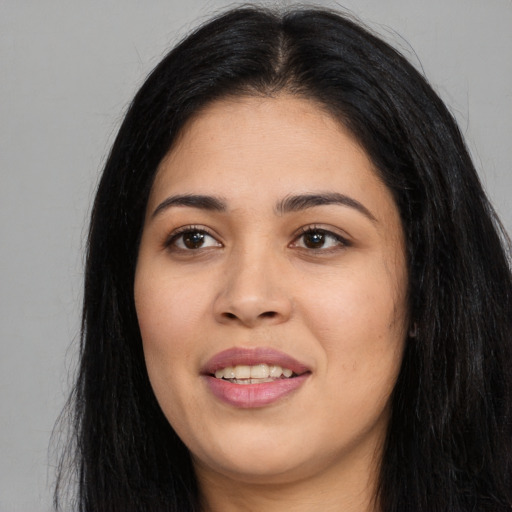 Joyful asian young-adult female with long  black hair and brown eyes