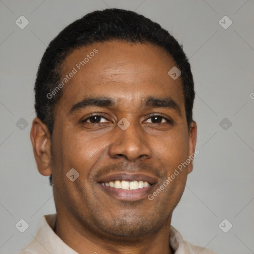 Joyful latino young-adult male with short  black hair and brown eyes