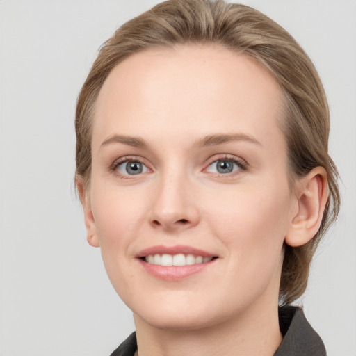 Joyful white young-adult female with medium  brown hair and blue eyes