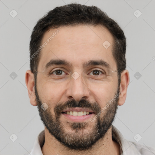 Joyful white adult male with short  black hair and brown eyes