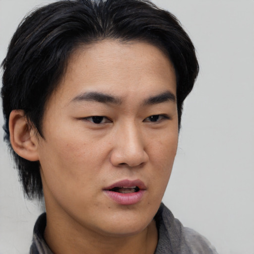 Neutral asian young-adult male with short  black hair and brown eyes
