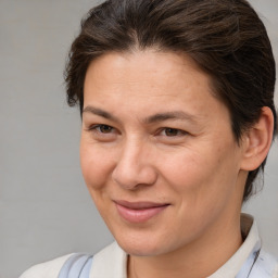 Joyful white adult female with medium  brown hair and brown eyes