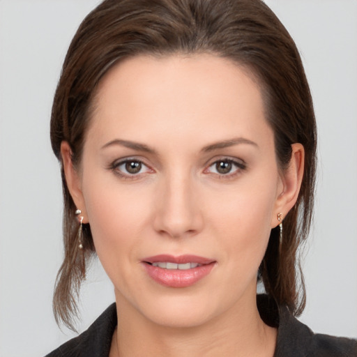 Joyful white young-adult female with medium  brown hair and brown eyes