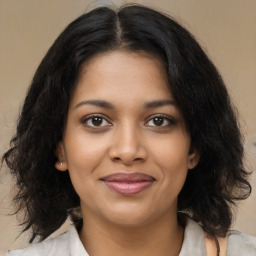 Joyful black young-adult female with medium  brown hair and brown eyes