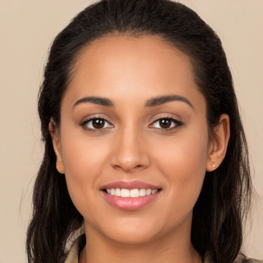 Joyful white young-adult female with long  brown hair and brown eyes