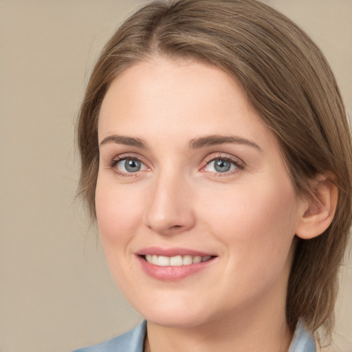 Joyful white young-adult female with medium  brown hair and grey eyes