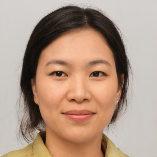 Joyful asian young-adult female with medium  brown hair and brown eyes