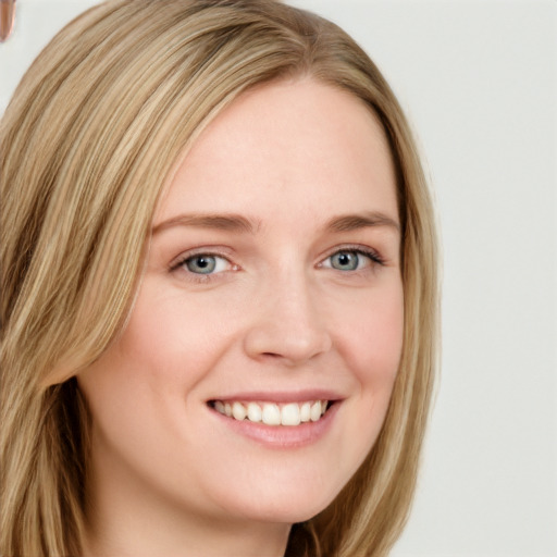 Joyful white young-adult female with long  brown hair and blue eyes