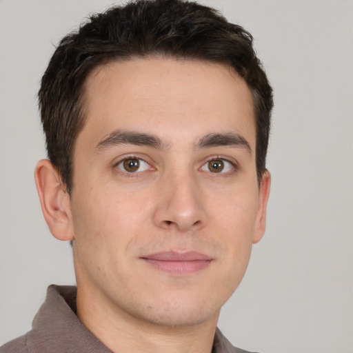 Joyful white young-adult male with short  brown hair and brown eyes