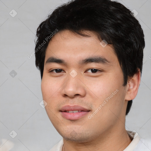 Joyful asian young-adult male with short  black hair and brown eyes