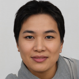 Joyful asian young-adult female with short  black hair and brown eyes