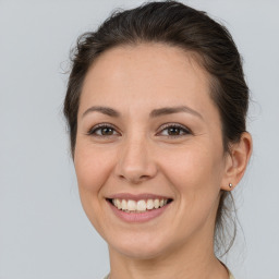 Joyful white adult female with medium  brown hair and brown eyes