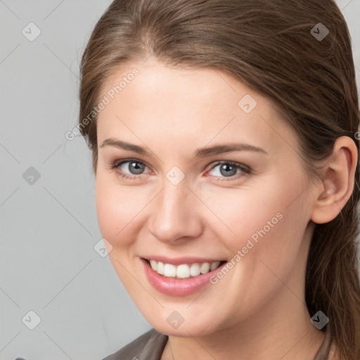 Joyful white young-adult female with long  brown hair and grey eyes