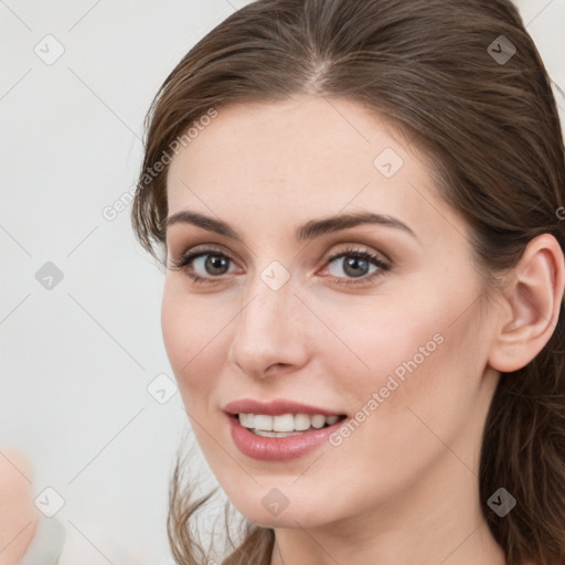 Joyful white young-adult female with long  brown hair and grey eyes