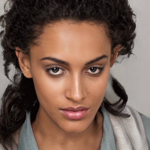 Neutral black young-adult female with long  brown hair and brown eyes