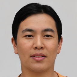 Joyful asian young-adult male with short  black hair and brown eyes