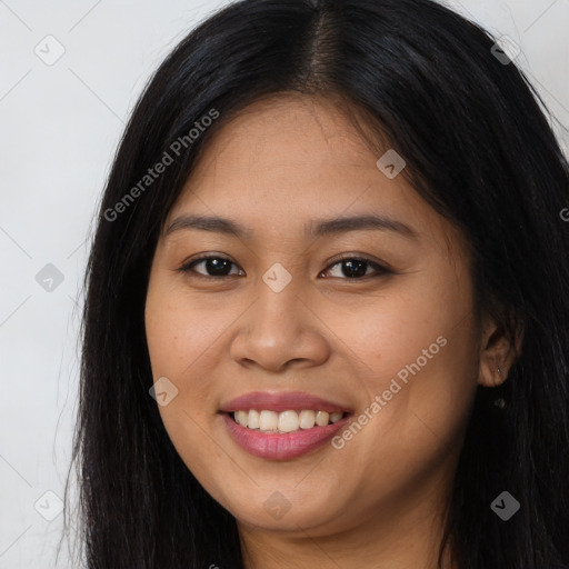 Joyful latino young-adult female with long  brown hair and brown eyes