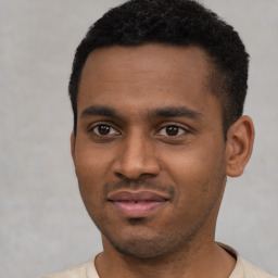 Joyful latino young-adult male with short  black hair and brown eyes