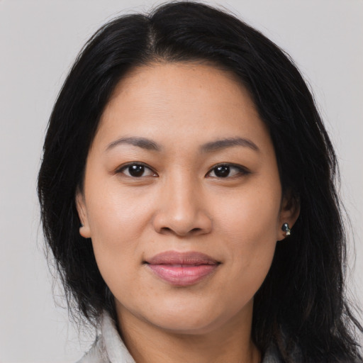 Joyful asian young-adult female with long  brown hair and brown eyes
