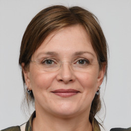 Joyful white adult female with medium  brown hair and grey eyes