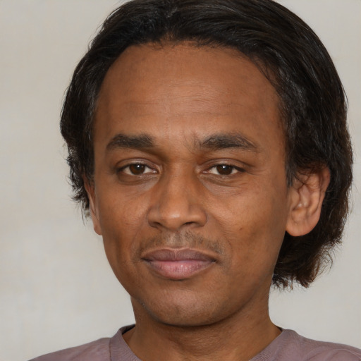 Joyful latino adult male with short  black hair and brown eyes