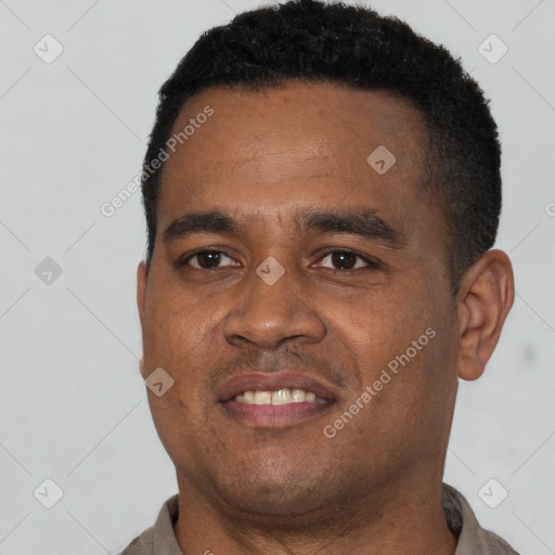 Joyful latino young-adult male with short  brown hair and brown eyes