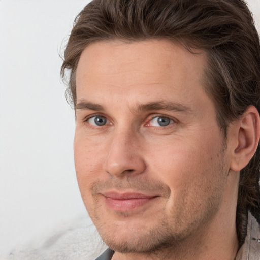 Joyful white adult male with short  brown hair and grey eyes