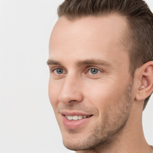 Joyful white young-adult male with short  brown hair and grey eyes