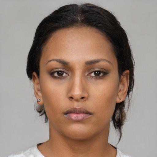 Neutral black young-adult female with medium  brown hair and brown eyes